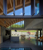 Open kitchen with concrete floor in architect's house with a curved roof