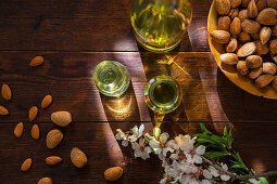 Spain, Baleares, Almonds and oil on wooden table