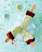 Cakesicles with icing and sprinkles