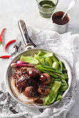 Asian meatballs with vegetables on noodles