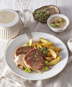 Fillet of beef with yogurt sauce and potatoes wedges