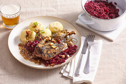 Roasted wild duck with red cabbage and dumplings