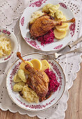 Roasted goose leg with two kinds of cabbage and dumplings