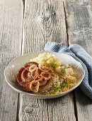 Sausage with sauerkraut and onion rings