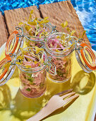 Raw vegetable salad in jars