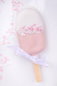 Pink and white cake lolly with white bow