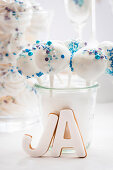 White cake pops with blue sugar sprinkles