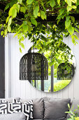 Patio corner with pendant light, green leaves and mirror