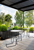 Terrace with minimalist furniture, view of the lake