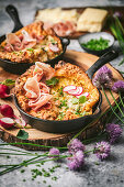 Mini Dutch-Baby with prosciutto, chive flowers and radishes