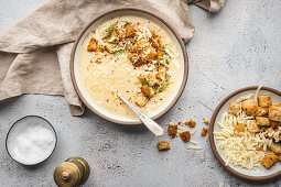 Cauliflower soup with croutons and cheese garnish