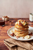 Pancakes with bananas, pecans, and maple syrup