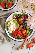 Mixed berries and spinach salad with feta and honey pecans