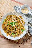 Dandan style ribbon noodles with chili, soy sauce, and peanut butter