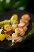 Scallops wrapped in bacon with grilled vegetables