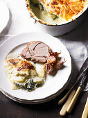 Slow roasted lamb with potato and spinach gratin