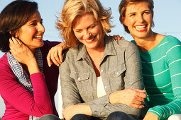 Three good-humoured girlfriends on a ship