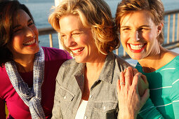 Three good-humoured girlfriends on a ship