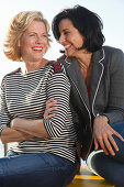 Three good-humoured girlfriends on a ship