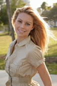 Blonde woman in light blouse dress outside