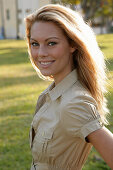 Blonde woman in light blouse dress outside