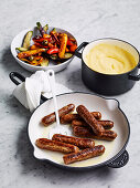 Cheesy polenta, with vegetarian sausages and ratatouille vegies