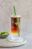 Tonic on ice with espresso topping and limes