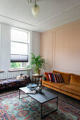 Orange-colored sofa, coffee table and bench in the living room