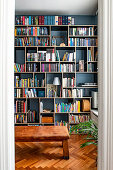 View of vintage bench and wall of books in the library