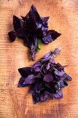 Two bunches of red basil on a wooden background