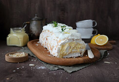 Meringue roll with lemon curd, cream cheese and almonds