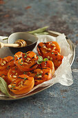 Grilled apricots with pine nuts, honey and sage