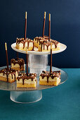 Cheesecake with chocolate icing on a stick