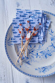 Cocktail napkins and skewers with fish decorations