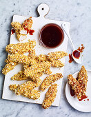 Popcorn coated chicken with honey BBQ sauce