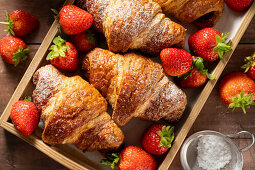 Classic French croissants with fresh strawberries