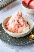 Grated frozen clementine on whipped cream