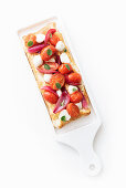 Puff pastry with mozzarella balls, cherry tomatoes and red onions