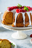 Bundt cake with vanilla glaze and raspberries