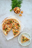 Quiche with chanterelles and onions in sour cream stuffing with cheese