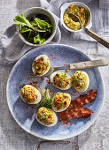 Deviled eggs with avocado and crispy bacon