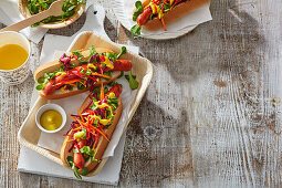 Grilled hot dogs topped with salad