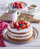 Walnut cake with whipped cream and fresh berries