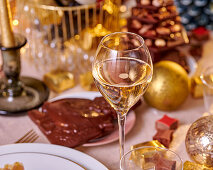 Ein Glas Champagner auf festlich gedecktem Tisch