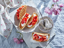 Sweet waffle tacos with strawberries and whipped cream