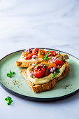 Bread topped with hummus, tomato ragout and dukkah
