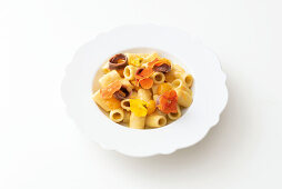 Macaroni with yellow tomatoes, edible flowers and anchovies