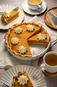 Pumpkin pie with whipped cream dollops