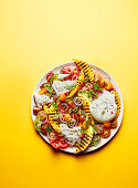 Grilled mango and tomato salad plate with burrata
