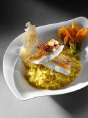 Pike-perch fried on the skin with saffron risotto and courgette flower